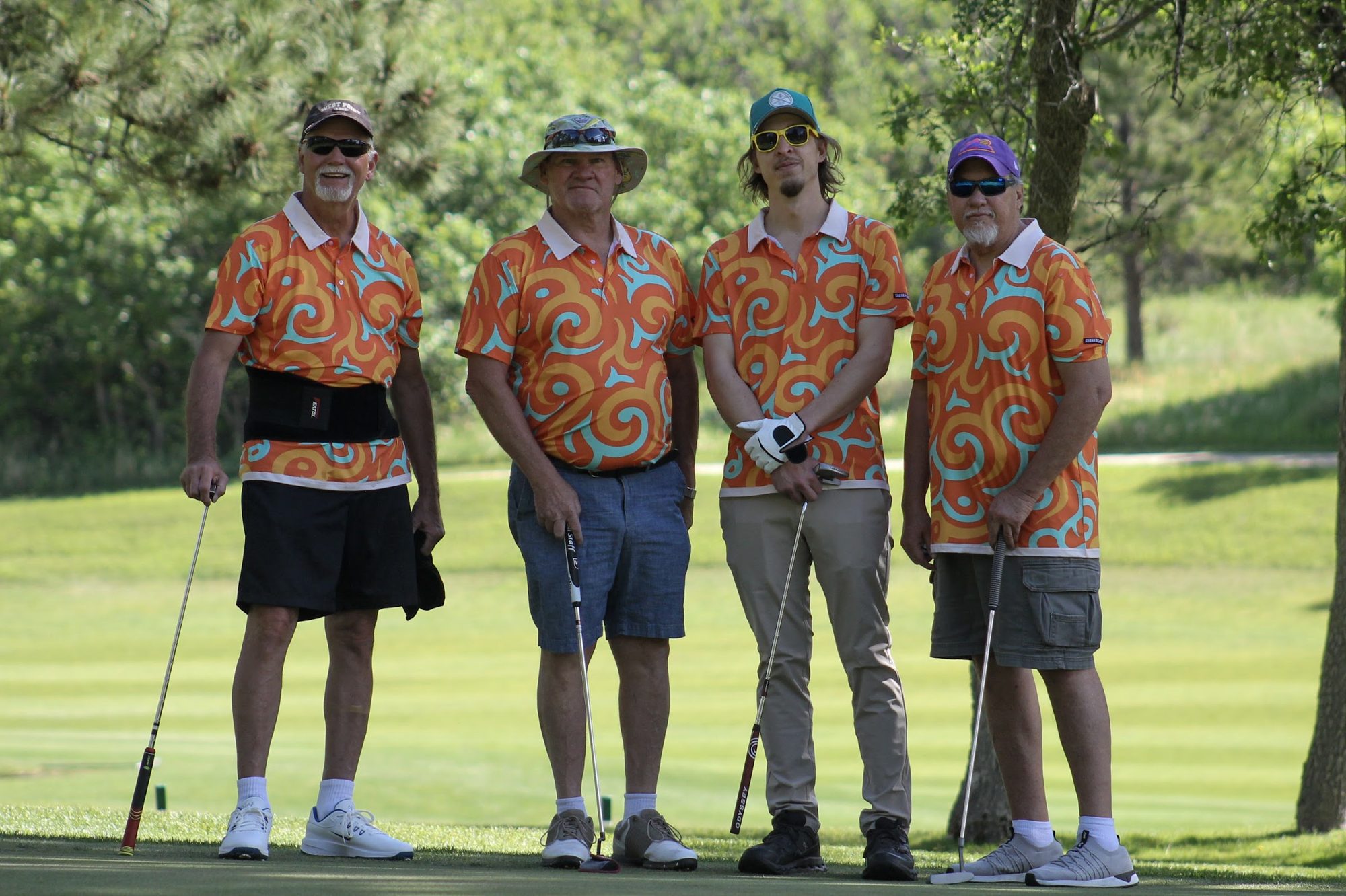 A foursome in matching orange shirts