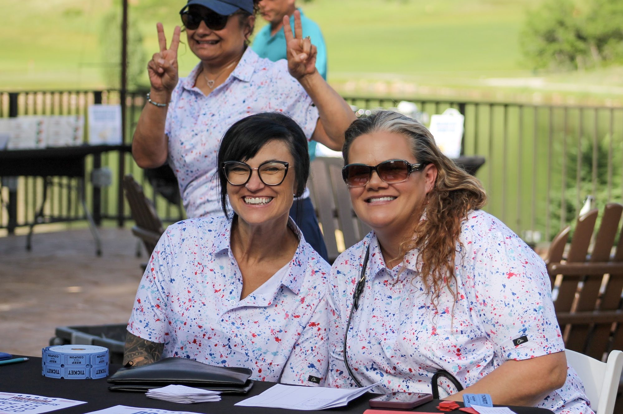 Volunteers smiling at the tournament registration table